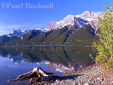 THE RUNDLE RESERVOIR reflecting the snowy peaks of 
the Rocky Mountains.  Canmore, Alberta, Canada, 
North America

