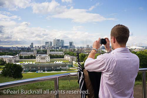 Man photographing the view to Canary Wharf from the 
Observatory using a compact digital camera. Venue for 
2012 Olympic games equestrian events. Greenwich 
London England UK Britain Europe 