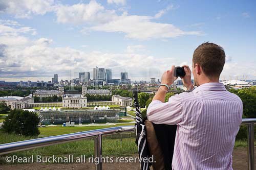 Man photographing the view to Canary Wharf from the 
Observatory using a compact digital camera. Venue for 
2012 Olympic games equestrian events. Greenwich 
London England UK Britain Europe 