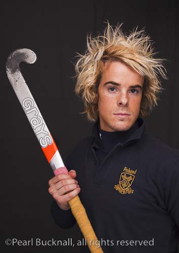 Head and shoulders portrait of a young man with a 
determined expression wearing a hockey shirt and 
holding a stick

Keywords: studio people sport sportsman
