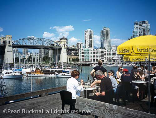 RESTAURANT on GRANVILLE ISLAND in False Creek, 
with the Burrard Bridge and Downtown Vancouver 
beyond. Vancouver, British Columbia, Canada, North 
America