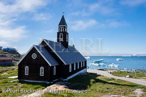18th century wooden Zions Kirke or Zion Church 
overlooking Disco Bay with icebergs floating. 
Ilulissat (Jakobshavn), Qaasuitsup, Greenland