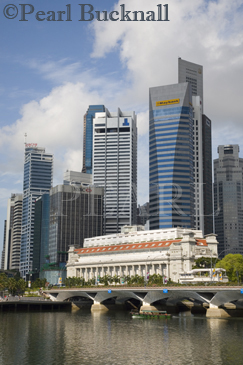 Old Fullerton Hotel building 1928 new skyscrapers in 
Raffles Place in Central Business District across Marina 
Bay at River mouth Singapore Asia
