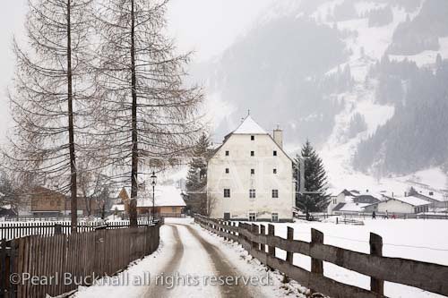 Rauris, Austria, Europe. Winter snow scene and lane to 
16th century historic building Furstenmuhle former 
bakery and mill 1565 in Alpine village

Keywords: Austrian, alps,
