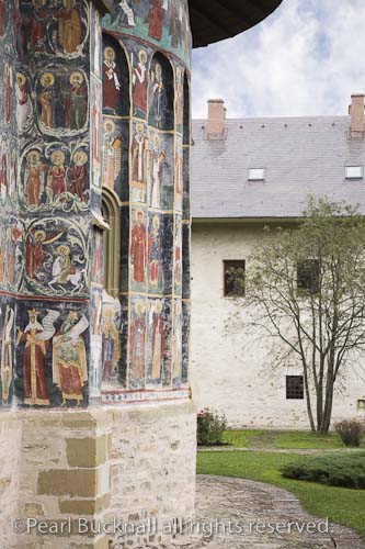 Painted church wall in fortified Sucevita Monastery 
compound. Bucovina Moldavia Romania Europe

