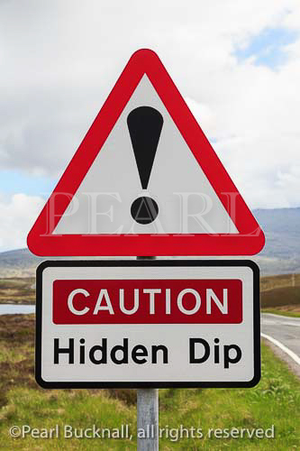 Triangular road sign warning Caution Hidden Dip with 
exclamation mark. South Uist, Scotland, UK, Britain, 
Europe
