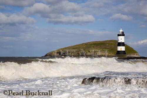 Penmon lighthouse and rough sea on rocky coast at 
Penmon Point Anglesey North Wales UK

Keywords: landscape landmark nobody scenic sea 
water weather

