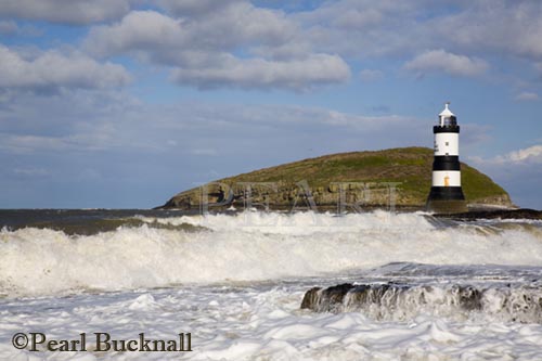 Penmon lighthouse and rough sea on rocky coast at 
Penmon Point Anglesey North Wales UK

Keywords: landscape landmark nobody scenic sea 
water weather

