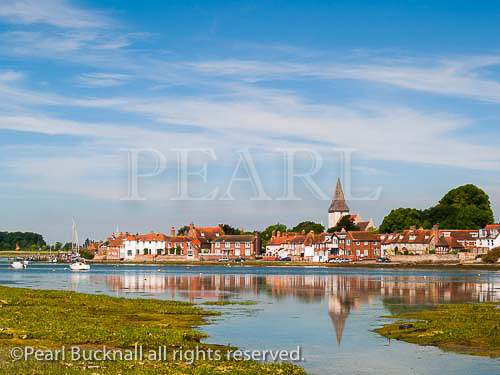 BOSHAM CREEK in Chichester harbour with the village 
and church reflected in still water. Bosham West Sussex 
England UK Britain

Keywords: Britain south coast picturesque village 
scenic
