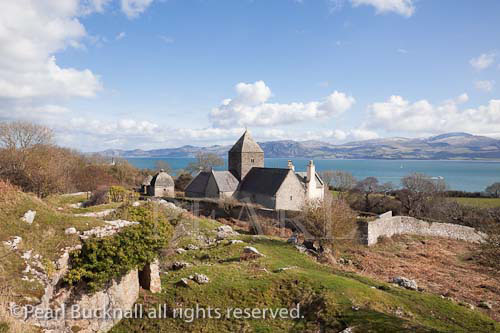 Penmon, Isle of Anglesey (Ynys Mon), North Wales, UK. 
Penmon Priory (St. Seiriol's monastery) and view to 
the 
North Wales coast across the Menai Strait.

Keywords: scenic landscape historic landmark heritage