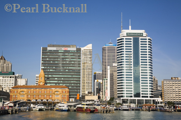 Ferries by wharf and neoclassical Ferry Building 1912 
on waterfront with skyscrapers in Central Business 
District from Waitemata harbour Auckland North Island 
New Zealand 
0