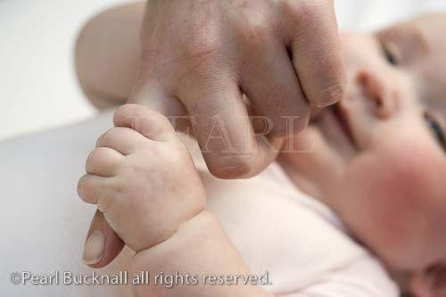 Three month old baby girl holding mother's finger. 
Britain UK Europe

caucasian child kid mum parent bonding