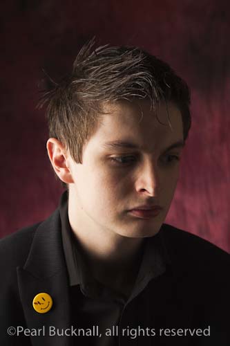 Head and shoulders portrait of a young man with a 
pensive expression

