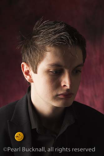 Head and shoulders portrait of a young man with a 
pensive expression

