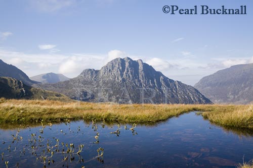 Tryfan mountain east face across Nant yr Ogof with 
pool of water reflecting blue sky in Snowdonia 
National Park. Ogwen, Conwy, North Wales, UK, Britain

Keywords: welsh landscape national park rural 
scenic water