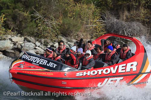 People having fun Jet boating on the Shotover River at 
Arthurs Point Queenstown South Island New Zealand. 