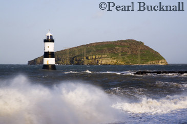 Penmon Point Lighthouse and Puffin Island with rough 
sea at high tide in winter. Penmon Anglesy North 
Wales 
UK

Keywords: coast island landmark landscape scenic sea 
stormy water wave weather