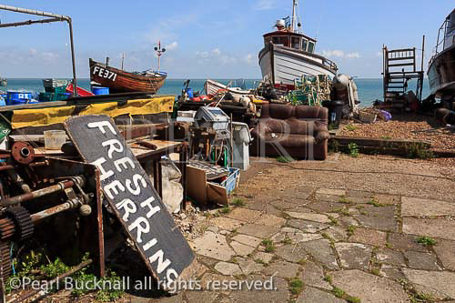 Fishing boats and sign for fresh herrings on the south 
coast beach in Deal, Kent, England, UK, Britain, Europe