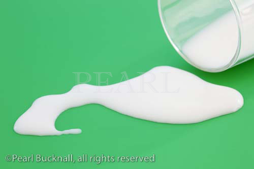 Milk spilt from a glass onto a green surface

Keywords: adage concept white liquid