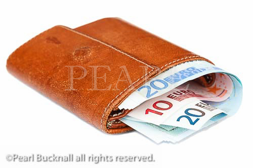 Old leather purse stuffed with Euro notes isolated on a 
white background