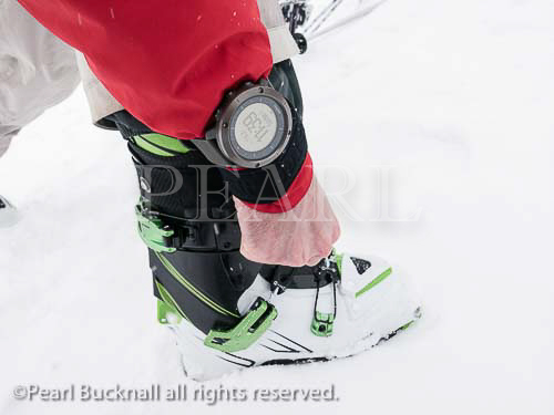 Skier adjusting alpine touring ski boots and wearing a 
Suunto Traverse GPS Watch for backcountry skiing 
navigation. Haute Savoie, Rhone-Alpes, France