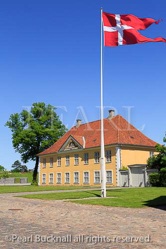 Danish flag by the Commander's House 1725 in 
Kastellet or fortified Frederikshavn Citadel in 
Copenhagen, Zealand, Denmark, Scandinavia, Europe
