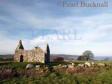 CAPEL LLIGWY, remains of 12th century chapel with 
Lligwy Bay beyond.  Moelfre, Anglesey, Wales, UK

