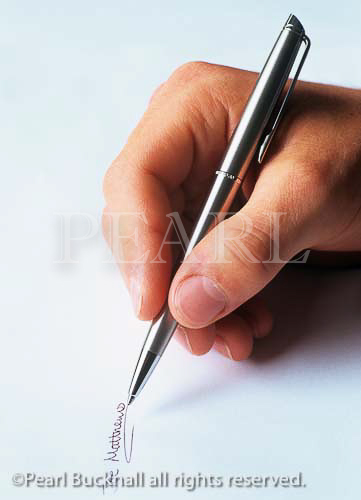 Man's hand writing a signature on plain paper with a 
silver ball point pen.