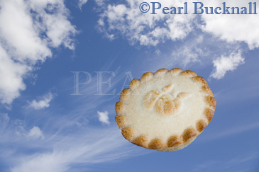 Pie in the Sky crinkle edged pastry pie flying in blue 
sky with fluffy white fair weather cummulus and high 
wispy white Cirrus or Mares Tail clouds

Keywords: concept 
