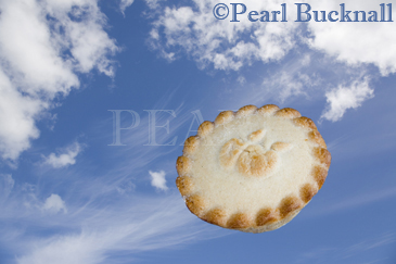 Pie in the Sky crinkle edged pastry pie flying in blue 
sky with fluffy white fair weather cummulus and high 
wispy white Cirrus or Mares Tail clouds

Keywords: concept 
