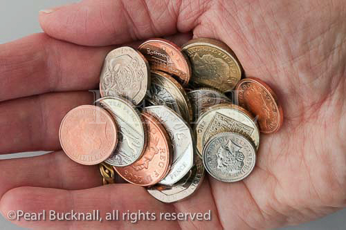 Elderly person pensioner holding a variety of British 
coins in palm of hand. UK Britain. MR 09/04