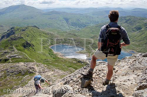 Hikers scrambling up Crib Goch at start of 
Snowdon Horseshoe in mountains of Snowdonia 
National Park, Gwynedd, North Wales, UK, Britain, 
Europe.