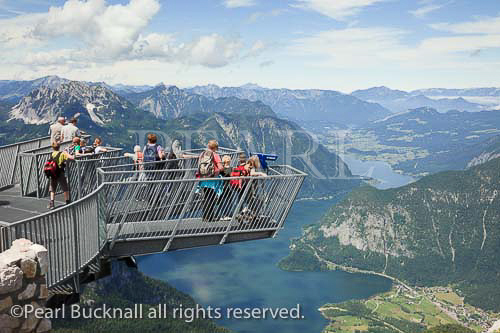 Children on 5fingers viewing platform on Krippenstein 
mountain at Dachstein World Heritage site with high 
view to Hallstattersee lake in Austrian Alps near 
Obertraun, Salzkammergut, Austria, Europe. 