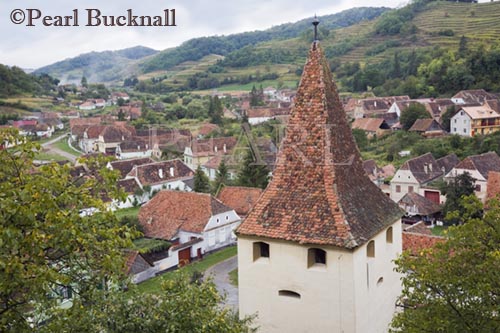 Tower and village red tiled rooftops from Saxon 
fortified church. Biertan Transylvania Romania Europe


