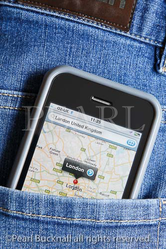 An Apple iPhone displaying Google maps for the 
London area in the back pocket of a pair of blue denim 
jeans. England, UK, Britain, Europe