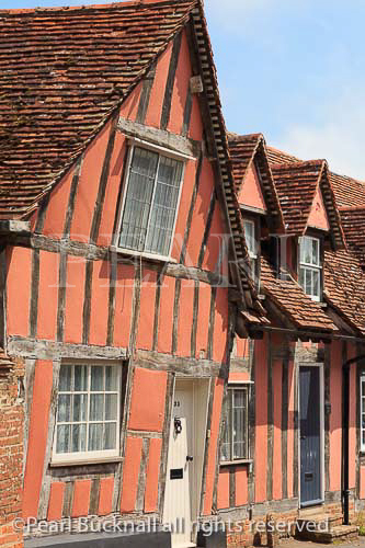 Orange timbered cottages in medieval village of 
Lavenham, Suffolk, England, UK, Britain, Europe
