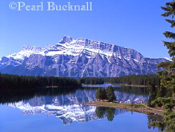 MOUNT RUNDLE REFLECTED in TWO JACK LAKE in Banff 
National Park in the Rocky Mountains in summer.  
Banff, Alberta, Canada, North America

