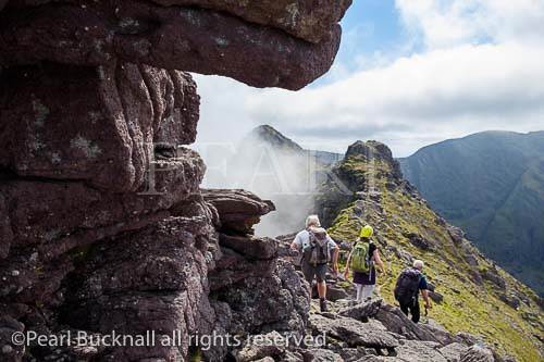 Rocky Beenkeragh or Binn Chaorach ridge with 
hikers hiking to Carrauntoohil in MacGillycuddy 
Reeks, Killarney, County Kerry, Eire, Southern 
Ireland, Europe