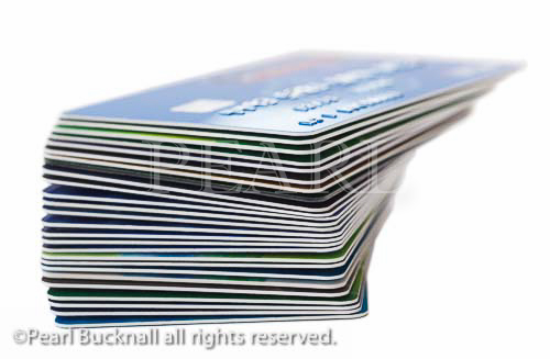 Stack of bank cards isolated on a white background. 
England, UK, Britain, Europe