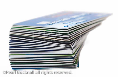 Stack of bank cards isolated on a white background. 
England, UK, Britain, Europe