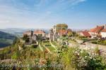 Picturesque hilltop village with garden flowers in 
foreground in Chateau Chalon, Jura, Franche-Comte, 
France, Europe. One of Les Plus Beaux Villages de 
France.