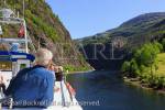 Tourists on a sightseeing cruise boat along narrow 
Mostraumen fjord from Bergen, Hordaland, Norway, 
Scandinavia, Europe