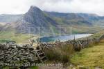 Ladder stile over a dry stone wall with a view to Mount 
Tryfan and Llyn Ogwen lake on footpath to the 
Carneddau mountains in Snowdonia National Park, 
Conwy, North Wales, UK, Britain