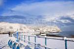 Snow on the seafront and beach in winter. Benllech, 
Isle of Anglesey, North Wales, UK, Europe. 

Keywords: coast scene snowfall Britain British weather 
Welsh