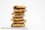 Pile of chocolate chip biscuits on a white background

Keywords: food nobody closeup studio
