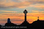 Celtic cross and Twr Mawr lighthouse in silhouette on 
Llanddwyn Island at sunset. Newborough, Isle of 
Anglesey, North Wales, UK, Europe

Keywords: setting sun sky Britain British Welsh 
heritage Ynys Mon