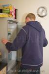 Man looking in a refrigerator with open door in 
kitchen at lunch time. England Britain UK Europe

person fridge caucasian house indoors