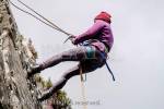 Female rock climber abseiling with safety rope on a 
rockface. Snowdonia, North Wales, UK, Britain, 
Europe