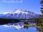 MOUNT RUNDLE REFLECTED in TWO JACK LAKE in Banff 
National Park in the Rocky Mountains in summer.  
Banff, Alberta, Canada, North America

