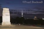 World War memorial cenotaph Court of Honour outside 
museum building floodlit at night in Auckland Domain 
with Skytower in dark sky Auckland North Island New 
Zealand 

